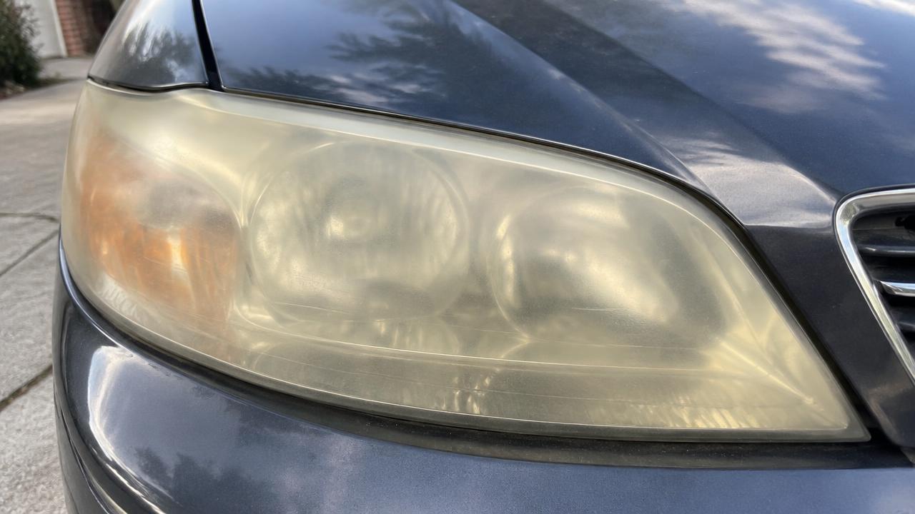 Car headlight before restoration — yellowed and oxidized lens
